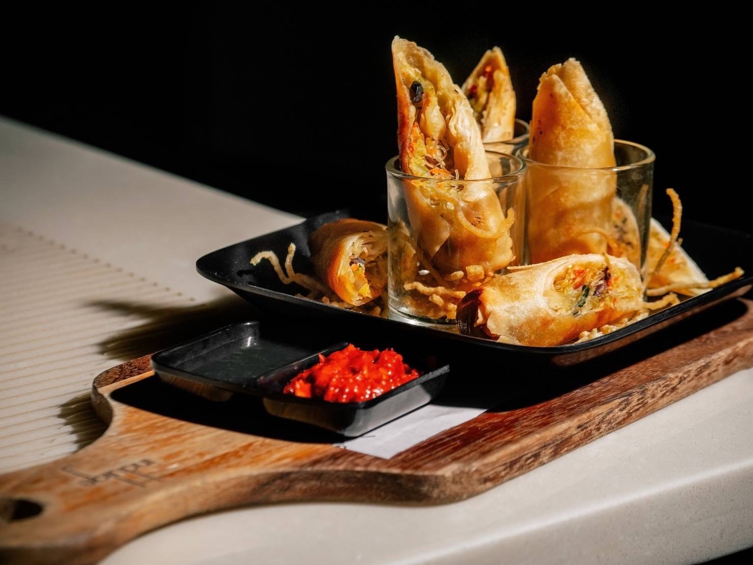 Crispy Thai spring rolls with vegetable filling and sweet chili sauce