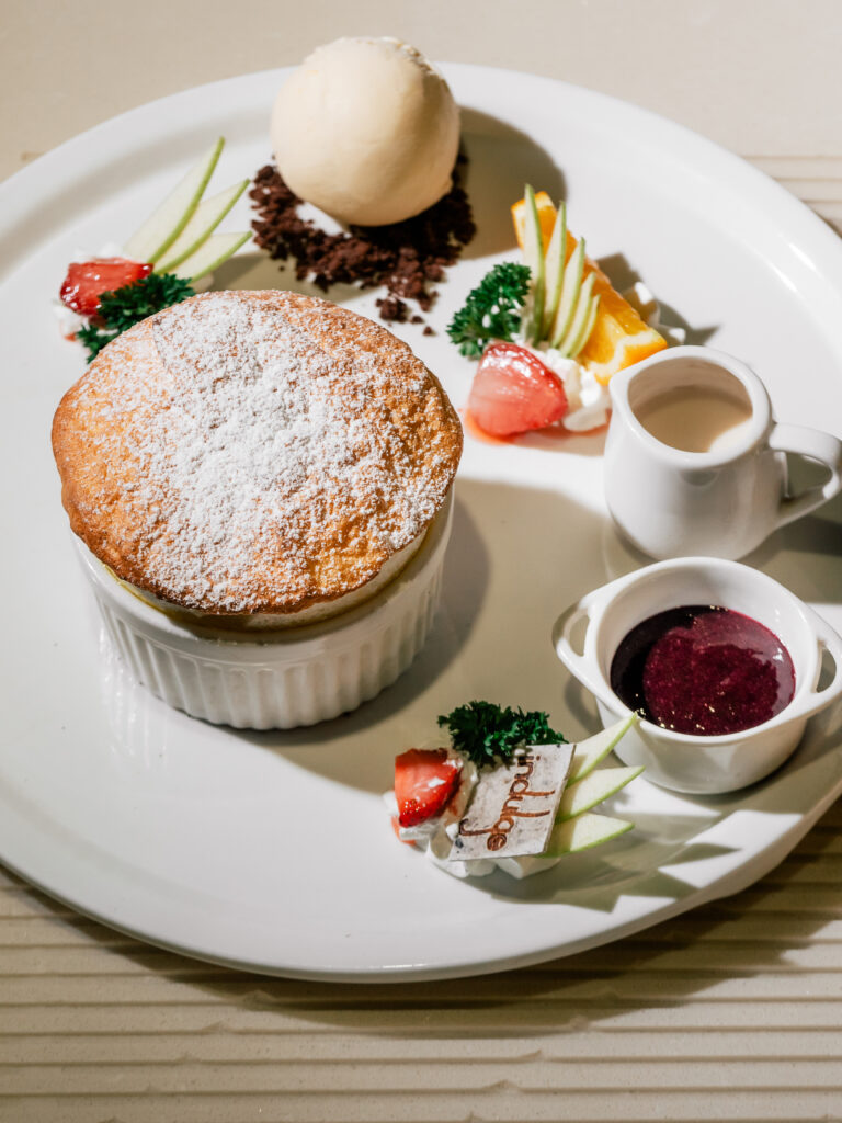 Dr. Lemons Cure warm lemon soufflé with vanilla ice cream and berry jelly