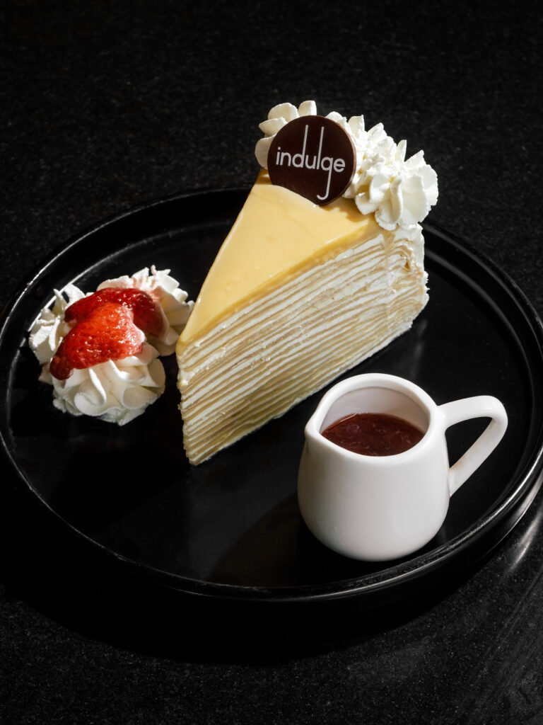 Vanilla Crepe Cake with layered vanilla crepes and strawberry sauce